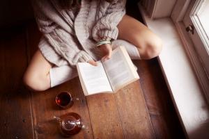 woman reading a book by hte window, 6 hacks that will make your relationship stronger, by healthista