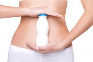 woman with probiotic drink, 7 diet myths, by healthista