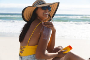 Sunscreen-redness-vitamin-D-12-surprising-facts-about-the-sun-and-your-skin-woman-in-sunhat-applying-sunscreen.jpg 