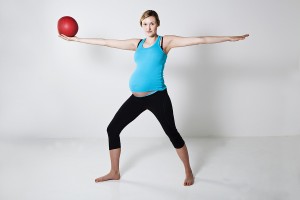 Pregnant woman exercising with exercise ball