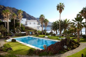 The hotel pool sits in lush, verdant gardens