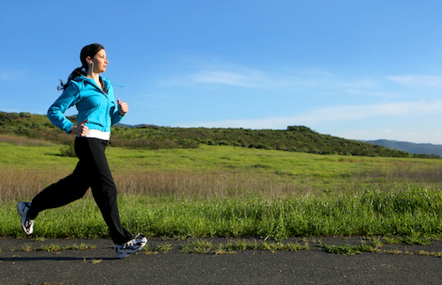 Young woman running on a trail