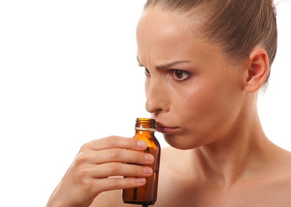 woman_smelling_bottle_resize