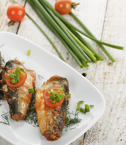 Sardines In Tomato Sauce In A White Dish