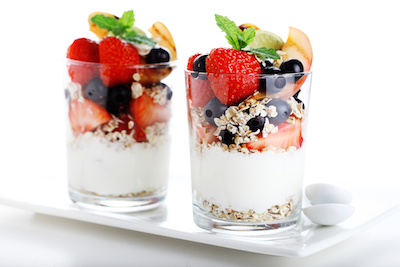 muesli with yogurt and fresh berries on a white isolated background