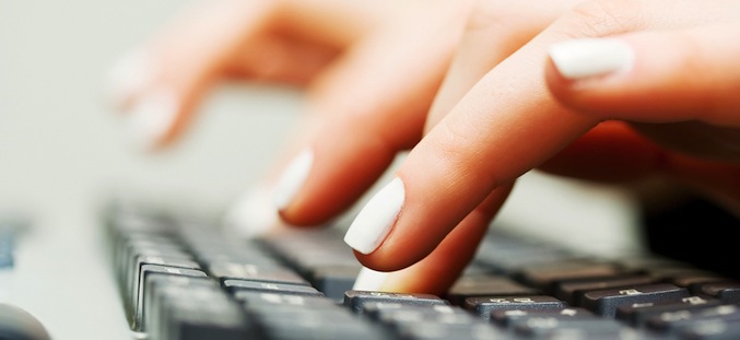 Female hands typing on the computer keyboard.