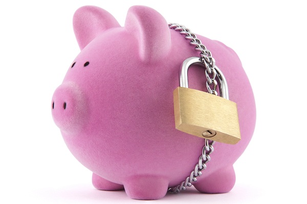 Piggy bank secured with padlock and chain. Clipping path included.