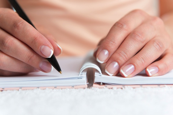 Young Female Is Writing Notes