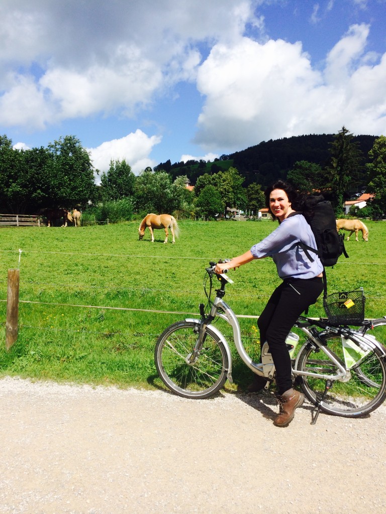 bavaria woman biking by horses