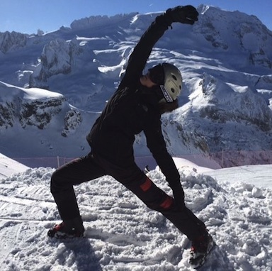 Yoga instructor Rachel doing a Reverse Warrior yoga pose in ski suit in Italy mountains, Snowga - the perfect preparation and recovery lesson for skiing season, by Healthista.com