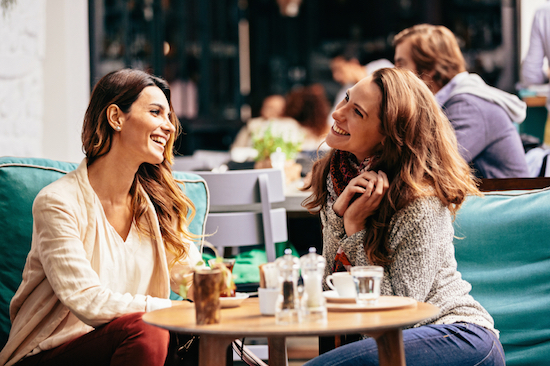 Two friends having coffee, How to beat low energy levels and avoid the afternoon slump, by Healthista.com