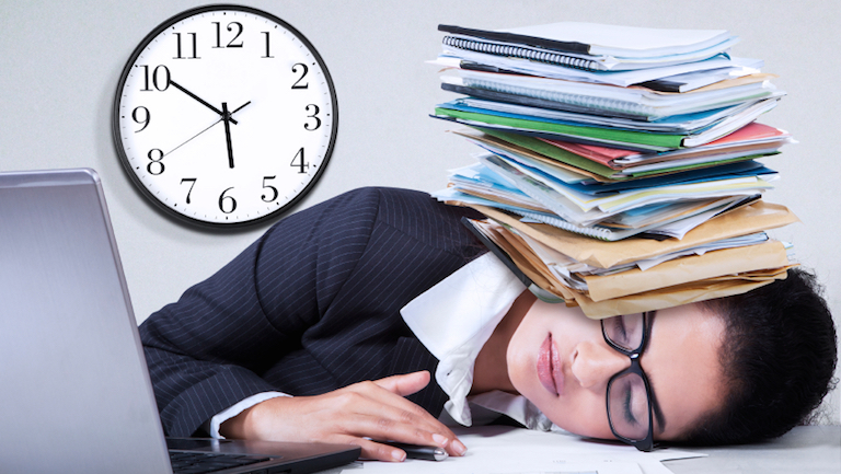 Woman sleeping on desk, How to beat low energy levels and avoid the afternoon slump, by Healthista.com