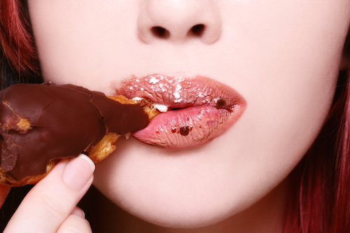 Woman eating profiteroles,  Three Stress Relief Foods to Have on Hand, by Healthista.com