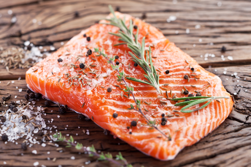 salmon on carving board, grocery list to help fight fatigue by healthista.com