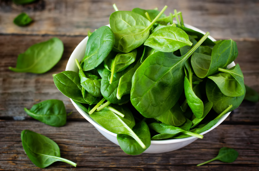 spinach in glass bowl, grocery list to help fight fatigue by healthista.com