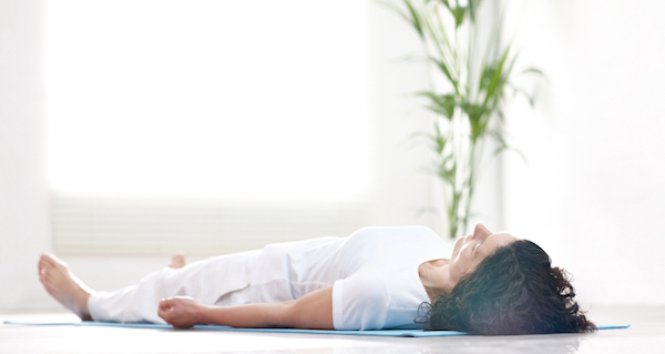 woman lying on the floor, by Healthista.com