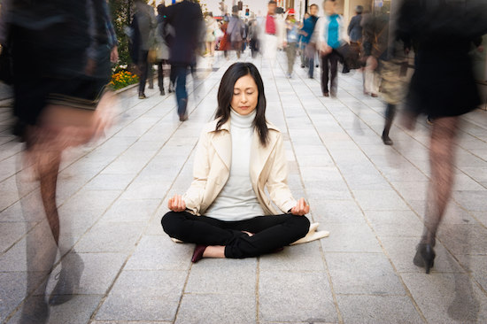 woman meditating on the street