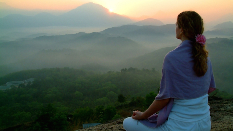 woman-overlooking-mountains-at-sunrise-meet-your-ant-stress-and-anti-ageing-hormones-by-Healthista.com