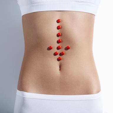 womans-stomach-with-tablets-on-it-how-your-gut-can-heal-your-brain-by-healthista.com