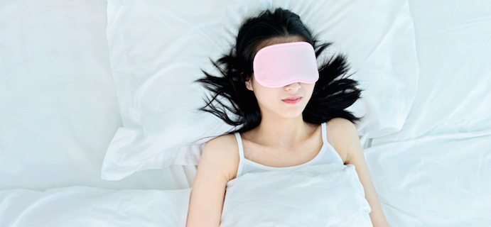 Young attractive woman sleeping in sleep mask