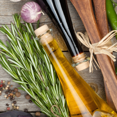 Herbs, spices and seasoning with utensils over wooden table background with copy space