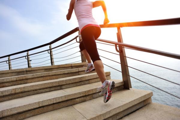 woman running up stairs, ways to improve brain health, by healthista.com