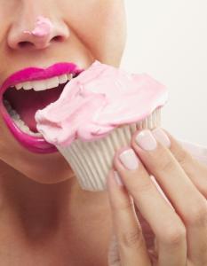 woman eating cupcake, low sugar christmas, by healthista.com