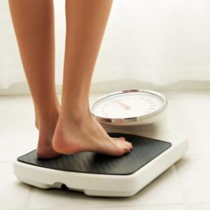 Woman's feet on scales, should I eat meat by healthista.com