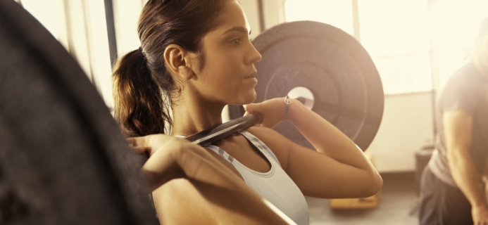 woman lifting weights fitness trends to stay by Healthista