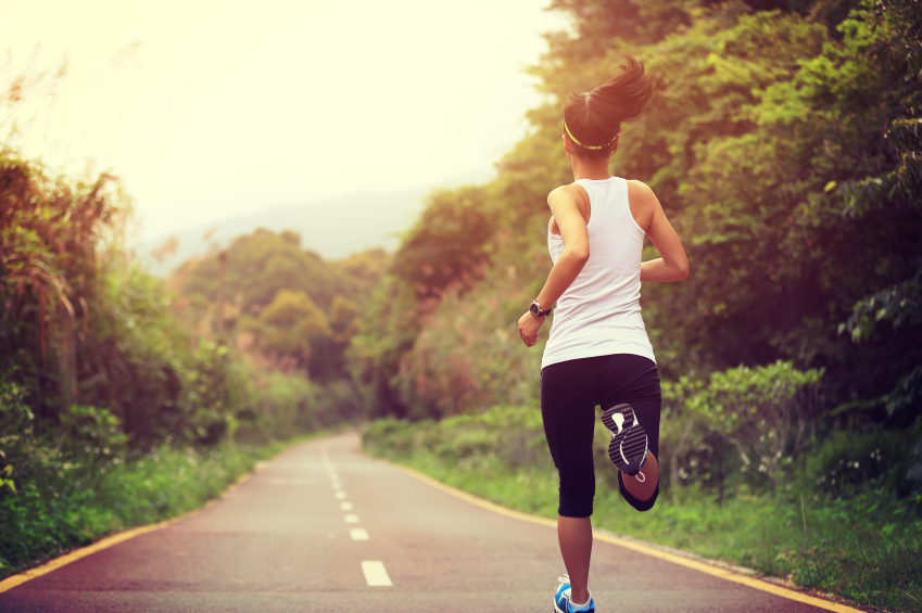 young fitness woman runner running on trail