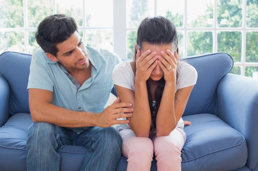 Boyfriend comforts crying girlfriend on the couch, relationship problems, by healthista