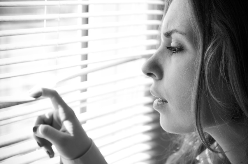 Woman looking through shutters, relationship problems, by healthista