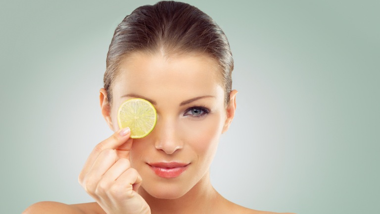 women with slice of lemon, what to eat for great skin, by healthista