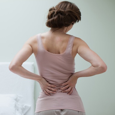 woman with back pain, 7 ways to get rid of back pain, by healthista.com