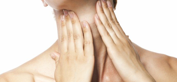 woman-touching-neck-thyroid-by-healthista