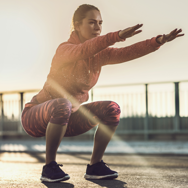 squatting-woman-in-sunshine-30-day-hiit-challenge-day-5-featured-by-healthista