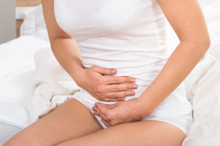 woman touching stomach Why sex hurts - the gynaecologist’s guide Healthista