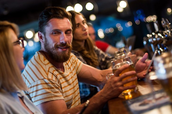 man with woman at bar Is my partner a serial cheater? Ask Sally Healthista