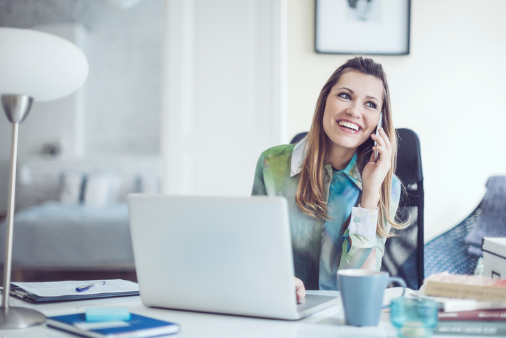 woman smiling on the phone, 8 best ways to be the most powerful version of you on International Women's Day by healthista