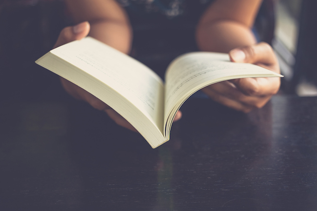 woman-holding-book-reading-novels-that-changed-your-life-healthista-body-image3.jpg