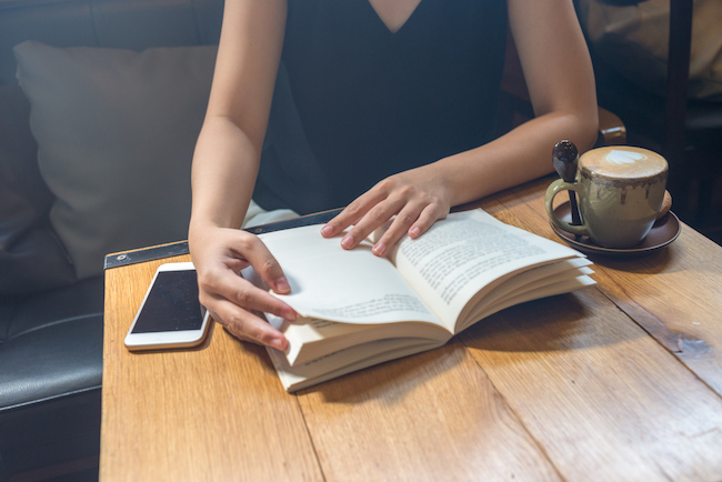 woman-reading-in-cafe-novels-that-changed-your-life-healthista-body-image2.jpg