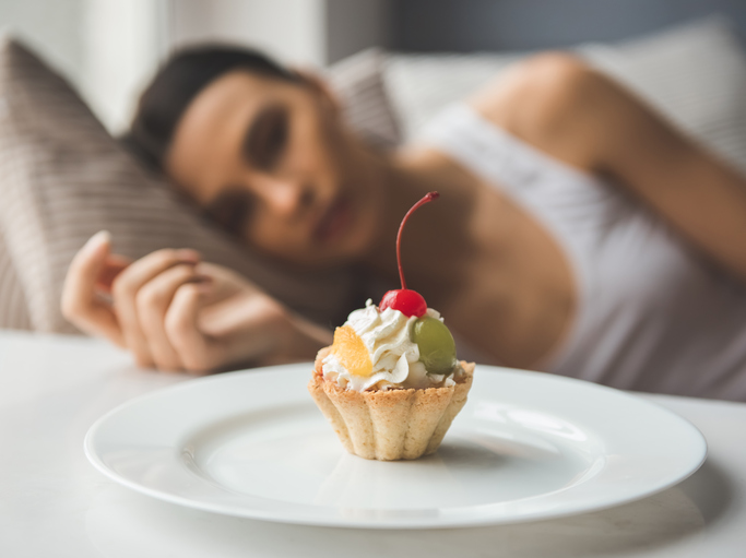 sad woman lying next to cake food shame 7 steps to going dairy-free without missing out on key nutrients plus 3 vegan recipes to help by healthista