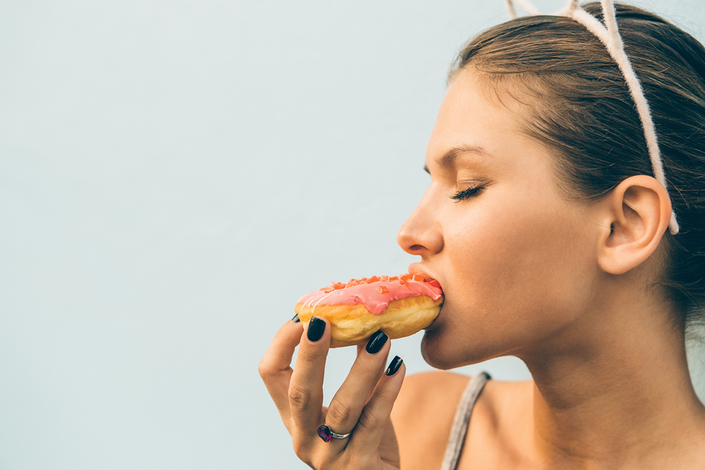 woman-eating-donut-sweet-binge.jpg