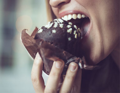 woman-eating-chocolate-muffin,-Fitness-fads-exposed---#2-'I've-been-to-the-gym-today-so-I-can-eat-whatever-I-like'-by-healthista.com