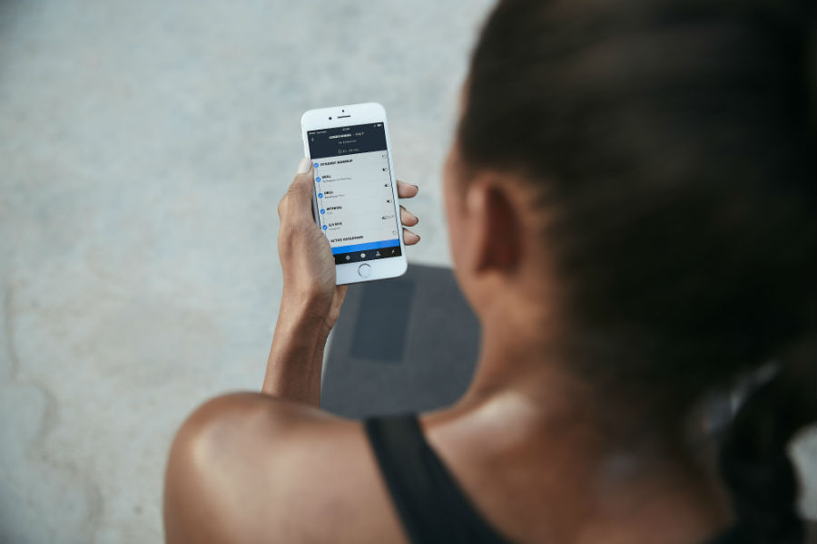 woman using app freeletics, the fitness app powered by AI that can give you your own tailored workout programme by healthista