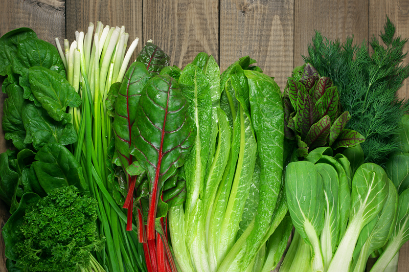 array-of-leafy-greens-on-cutting-board-9-foods-that-could-help-prevent-cancer-if-added-to-diet-healthista