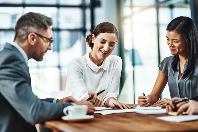 three-business-people-at-a-table-meeting-How-does-a-full-moon-affect-me-and-8-ways-to-live-by-the-phases-of-the-moon-healthista