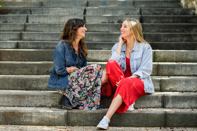 two-woman-talking-happily-on-stairs-How-does-a-full-moon-affect-me-and-8-ways-to-live-by-the-phases-of-the-moon-healthista