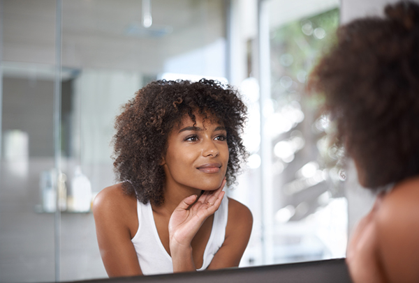 woman-looking-at-self-in-a-mirror-13-positive-affirmations-to-make-you-more-successful-in-life-healthista