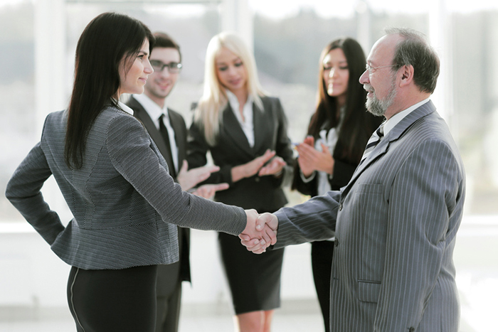 business-woman-shaking-hands-with-buisiness-man-11-life-lessons-from-Shaun-T-healthista